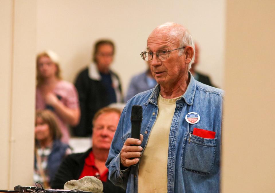 Roger Givens of Hutchinson, Kansas, speaks during the public comments portion of the special Nov. 14 meeting of the Kansas State Fair board. At the event, Givens wore a button that read, 'Save our track, Kansas State Fairgrounds. Stop the demo.'