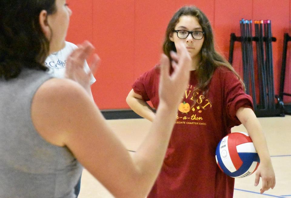 Argosy Charter School volleyball player Arianna Tello listens intently to coach Aly Dion at practice on Wednesday, Sept. 7, 2022.