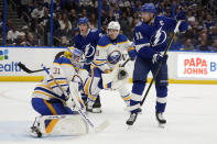 Buffalo Sabres goaltender Eric Comrie (31) makes a glove save on a deflection by Tampa Bay Lightning center Steven Stamkos (91) during the second period of an NHL hockey game Monday, April 15, 2024, in Tampa, Fla. (AP Photo/Chris O'Meara)
