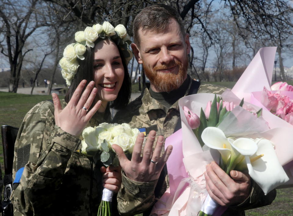 Members of the Ukrainian Territorial Defence Forces Anastasiia (24) and Viacheslav (43) attend their wedding ceremony, amid Russia's invasion of Ukraine, in Kyiv, Ukraine, April 7, 2022. REUTERS/Mykola Tymchenko