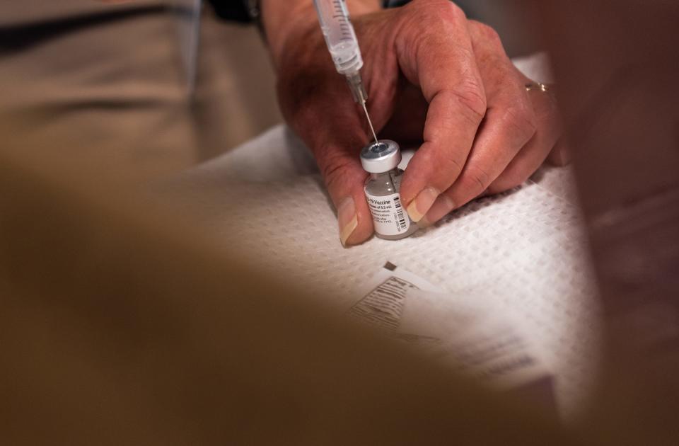 Benzie-Leelanau District Health Department registered nurse Dawn Hynds draws a dose of the Pfizer COVID-19 vaccine during a community vaccination event at Northport Public School in Northport on Sept. 16, 2021.