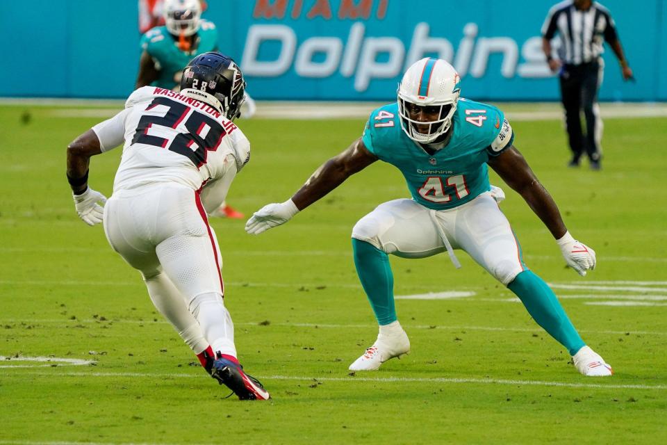 Miami Dolphins linebacker Channing Tindall (41) makes a tackle in the first quarter during a preseason game at Hard Rock Stadium on Friday, August 11, 2023, in Miami Gardens, FL.