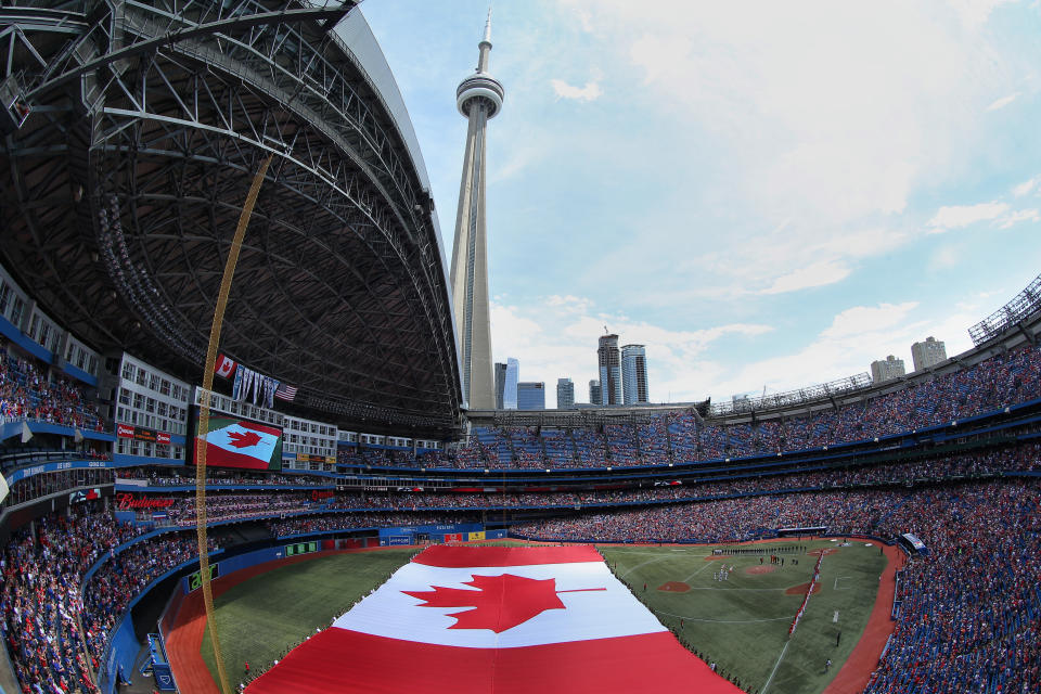 </a> TORONTO, CANADA - JULY 1: A general view of the Rogers Centre on Canada Day as a large Canadian flag is unfurled on the field during the singing of the Canadian anthem before the start of the Toronto Blue Jays MLB game against the Milwaukee Brewers on July 1, 2014 at Rogers Centre in Toronto, Ontario, Canada. (Photo by Tom Szczerbowski/Getty Images)Tom Szczerbowski Getty Images