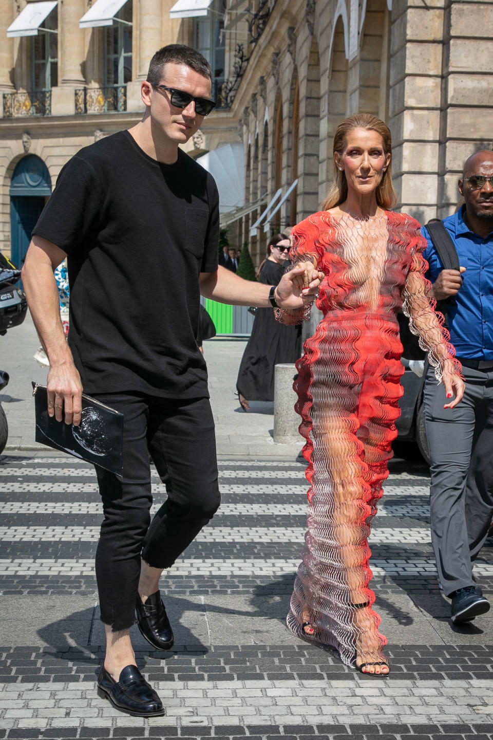 Pepe Munoz holds Celine Dion'd hand as she walks across the road. 