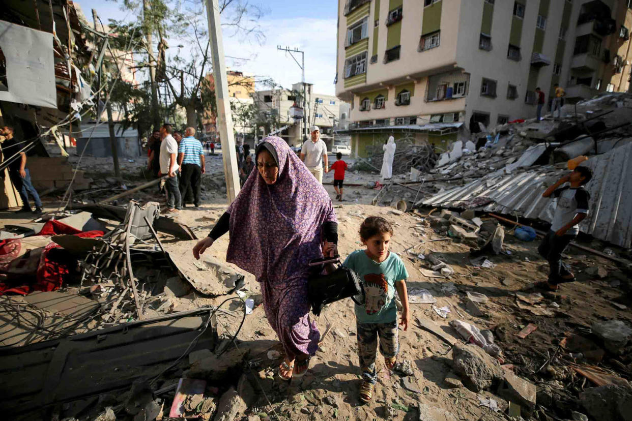 Image: Palestinians on a damaged Gaza City street after Israeli airstrikes on Saturday. (Majdi Fathi / NurPhoto via Getty Images)