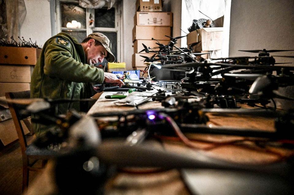 A Ukrainian serviceman is assembling a reusable bomber drone in Zaporizhzhia, Ukraine, on March 8, 2024.