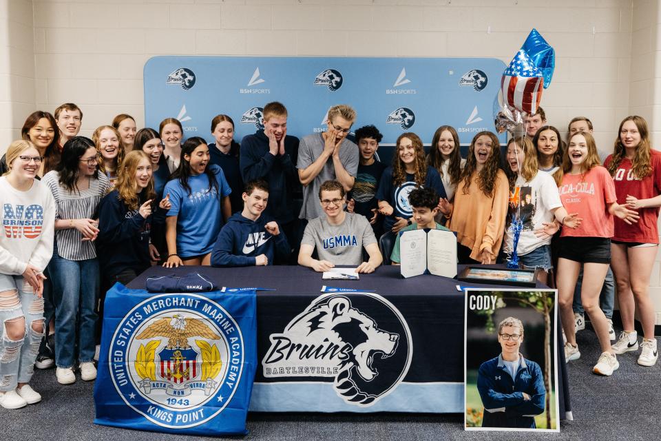 Cody Lay's teammates celebrate his commitment to attend the U.S. Merchant Marine Academy.