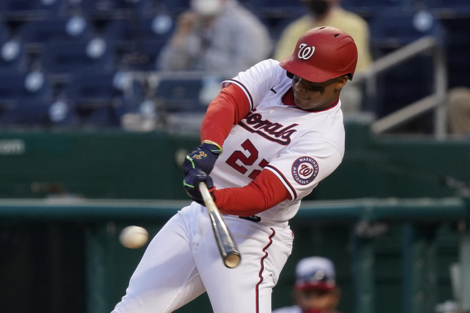 Washington Nationals' Juan Soto singles in the ninth inning of an opening day baseball game against the Atlanta Braves at Nationals Park, Tuesday, April 6, 2021, in Washington. Victor Robles scored on the play, and Washington won 6-5. (AP Photo/Alex Brandon)