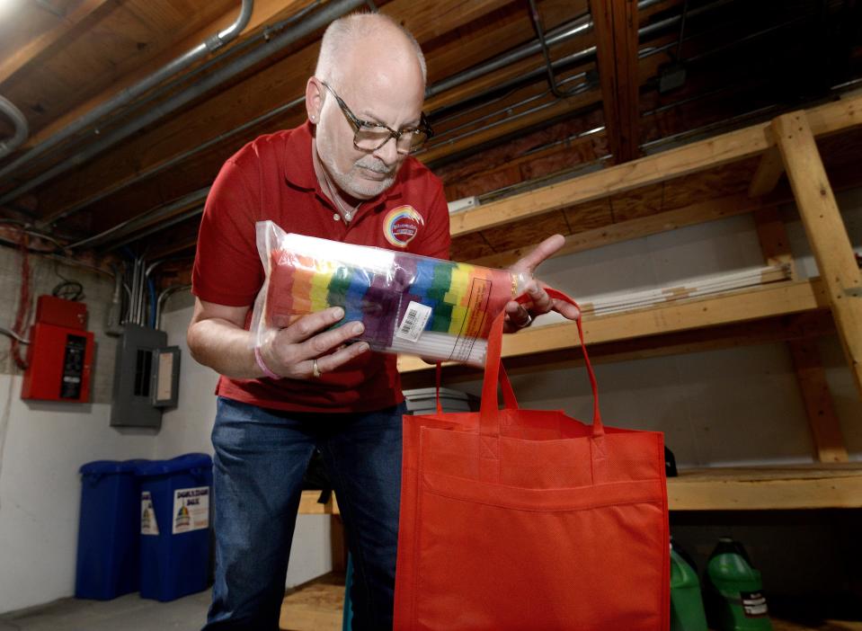 Director of Operations for the Phoenix Center Duane Williams packs up some pride flags on Wednesday, May 15, 2024, in preparations for Saturday's PrideFest.