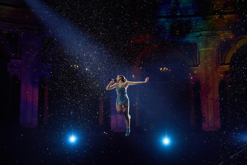 Dua Lipa performs 'Levitating' suspended above a stage.