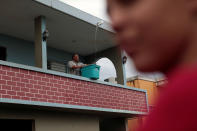 <p>A man collects rainwater with a container, after the island was hit by Hurricane Maria in Toa Baja, Puerto Rico, Oct. 16, 2017. (Photo: Alvin Baez/Reuters) </p>