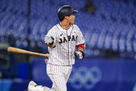 Japan's Tetsuto Yamada tosses his bat after hitting a three run double in the eight inning of a semi-final baseball game against South Korea at the 2020 Summer Olympics, Wednesday, Aug. 4, 2021, in Yokohama, Japan. (AP Photo/Matt Slocum)