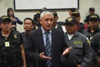 Guatemalan ex-President Otto Perez (C) speaks with journalists at the end of a hearing at the Supreme Court in Guatemala City on September 4, 2015