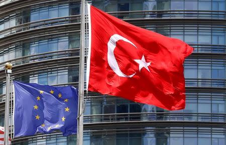 A European Union (L) and Turkish flag fly outside a hotel in Istanbul, Turkey, May 4, 2016. REUTERS/Murad Sezer/Files