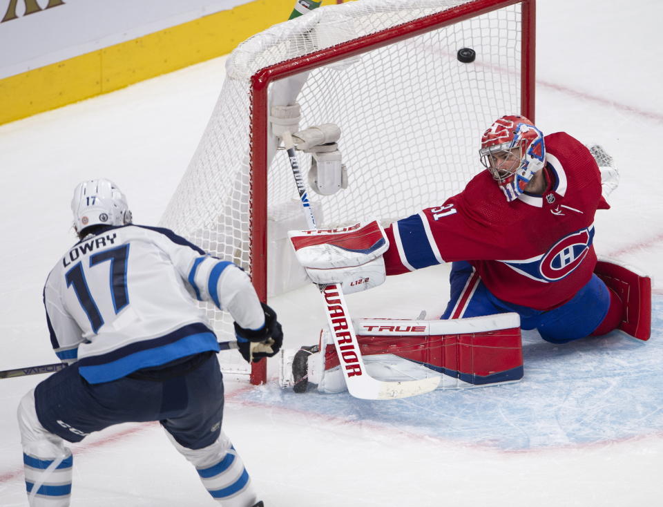 Winnipeg Jets' Adam Lowry (17) scores a goal against Montreal Canadiens goaltender Carey Price (31) during the second period of an NHL Stanley Cup playoff hockey game in Montreal, Sunday, June 6, 2021. (Ryan Remiorz/The Canadian Press via AP)