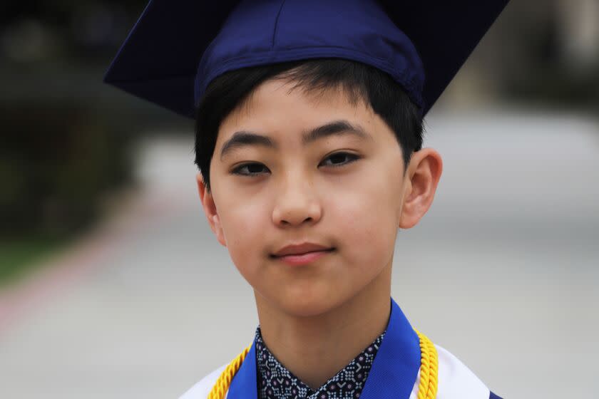 Clovis Hung, 12, of Diamond Bar, is set to graduate with the Fullerton College's class of 2023, he is the youngest person in college's 108 years to receive a degree, but he's not just receiving one degree, he's graduating with five degrees, he poses for a picture at Fullerton College in Fullerton on Friday, May 19, 2023. (Photo by James Carbone/ Los Angeles Times)