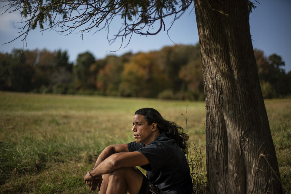 FILE - In this Sept. 25, 2020, file photo, Annawon Weeden sits for a portrait outside his home in Oakdale, Conn. As schools rethink Thanksgiving lessons, many are also looking to expand lessons on native cultures throughout the year. And while schools are increasingly turning to lessons created by native educators, some are also working to bring native voices directly into the classroom. A growing number of schools around Boston have started hosting annual visits from Weeden, a performing artist and member of the Mashpee Wampanoag Tribe. (AP Photo/David Goldman, File)