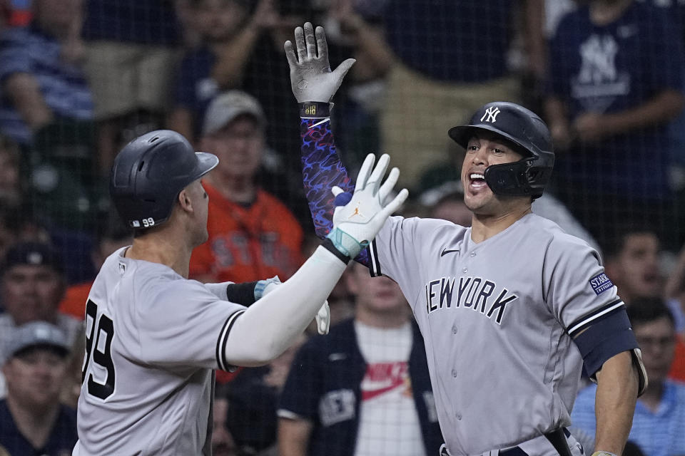 New York Yankees' Aaron Judge (99) celebrates with Giancarlo Stanton after hitting a solo home run against the Houston Astros during the third inning of a baseball game Saturday, Sept. 2, 2023, in Houston. (AP Photo/Kevin M. Cox)