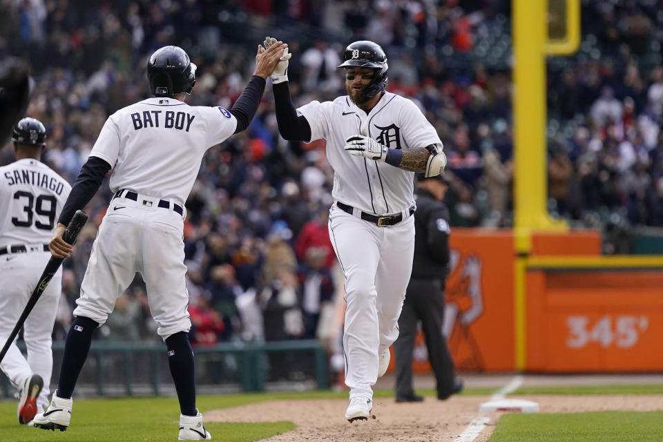 Detroit Tigers' Eric Haase is greeted by the bat boy after hitting a solo home run during the ninth inning of a baseball game against the Chicago White Sox, Friday, April 8, 2022, in Detroit. (AP Photo/Carlos Osorio)