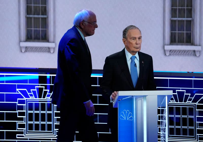 Senator Sanders walks behind former New York City Mayor Bloomberg during a break at the ninth Democratic 2020 U.S. Presidential candidates debate in Las Vegas Nevada, U.S.