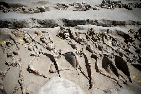 Skeletal remains, with iron shackles on their wrists, are laid in a row at the ancient Falyron Delta cemetery in Athens, Greece, July 27, 2016. REUTERS/Alkis Konstantinidis TPX IMAGES OF THE DAY