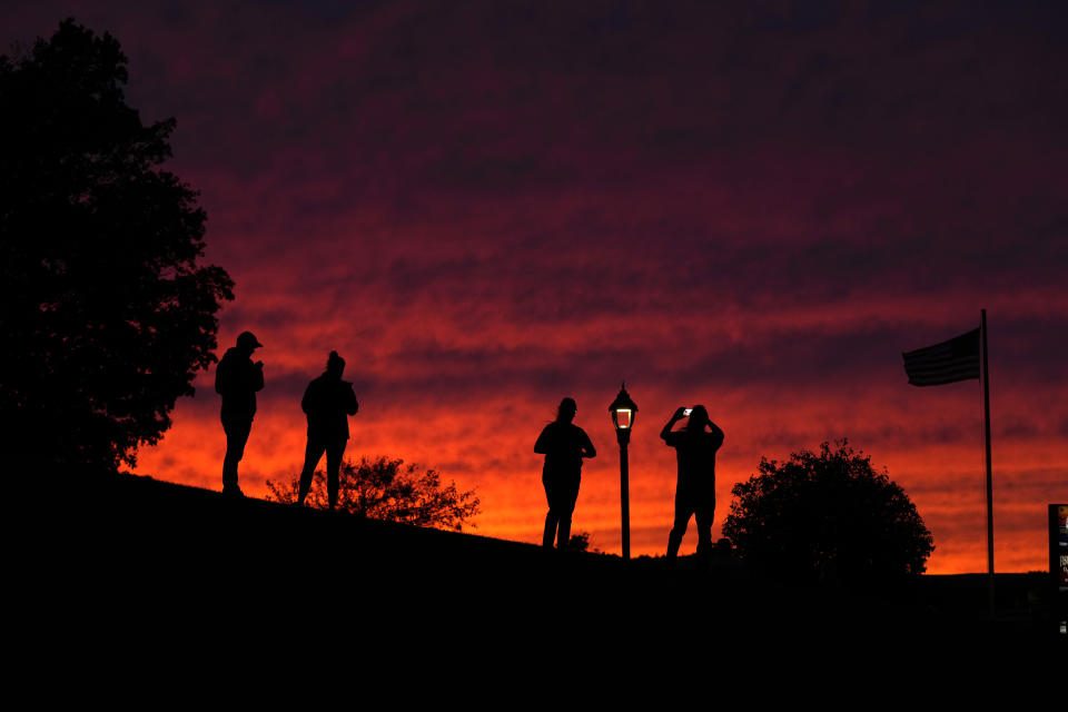 Visitors photograph the evening sky in advance of Hurricane Lee, Friday, Sept. 15, 2023, in Bar Harbor, Maine. Red skies at night usually portend fair weather but Saturday's weather is predicted to be stormy. (AP Photo/Robert F. Bukaty)