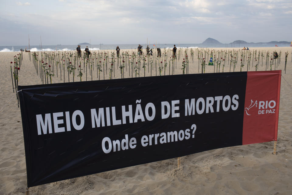 A banner that reads, "Half Million Dead. Where did we go wrong?" is seen in the sand on Copacabana beach in honor of 500,000 deaths during a protest against Brazilian President Jair Bolsonaro and his handling of the COVID-19 pandemic, in Rio de Janeiro, Brazil, Sunday, June 20, 2021. Brazil's COVID-19 death toll surpassed the milestone of 500,000 deaths on Saturday night. (AP Photo/Silvia Izquierdo)