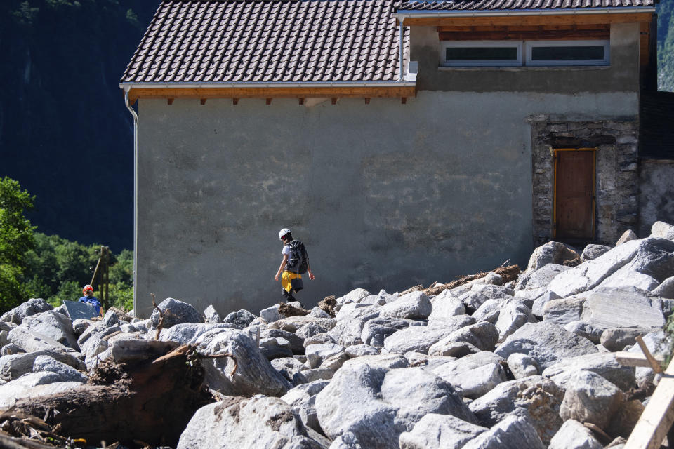 Cleanup work is underway at the Sorte village, community of Lostallo, Southern Switzerland, after a landslide, caused by the bad weather and heavy rain in the Misox valley, in Lostallo, Southern Switzerland, Saturday, June 22 2024. Massive thunderstorms and rainfall led to a flooding situation on Friday evening after a landslide in the Misox valley. Four people went missing on Saturday morning. Several dozen people had to be evacuated from their homes in the Misox and Calanca regions. (Samuel Golay/Keystone via AP)