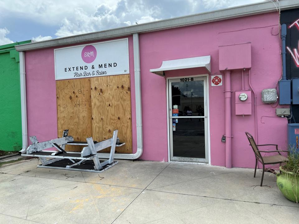 Extend and Mend Hair Bar and Salon boarded up on Monday as a precaution to impending Tropical Storm Ian.