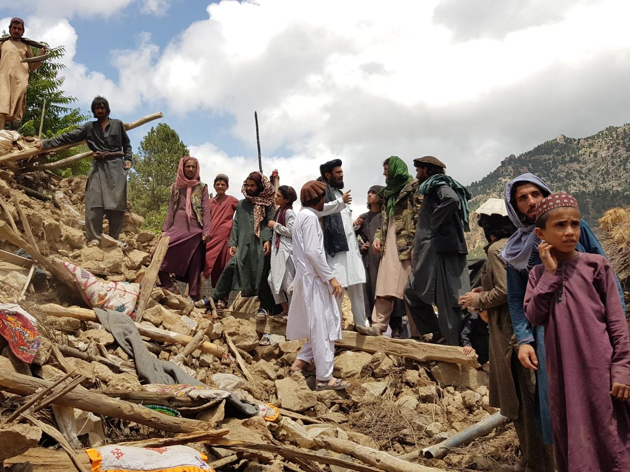 People help for the search and rescue operations on debris of a building after a magnitude 7.0 earthquake shook Afghanistan at noon and killed at least 29 people, and injured 62 others in the Spera district of Khost province near Paktika province, Afghanistan on June 22, 2022.