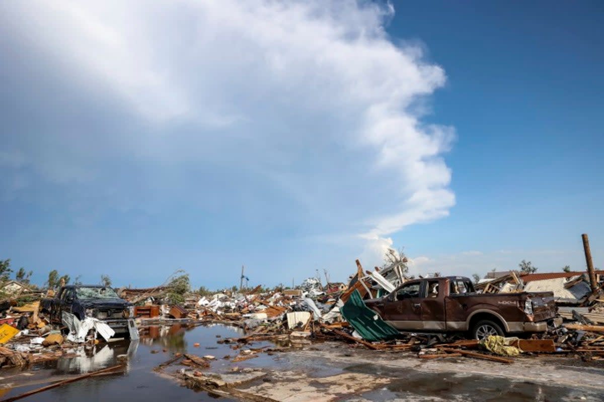 Damaged pickup trucks sit among debris after a tornado passed through a residential area in Perryton (AP)