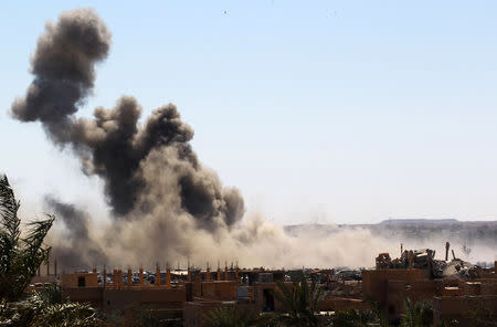 Smoke rises from the last besieged neighborhood in the village of Baghouz, Deir Al Zor province, Syria, March 18, 2019. REUTERS/Stringer