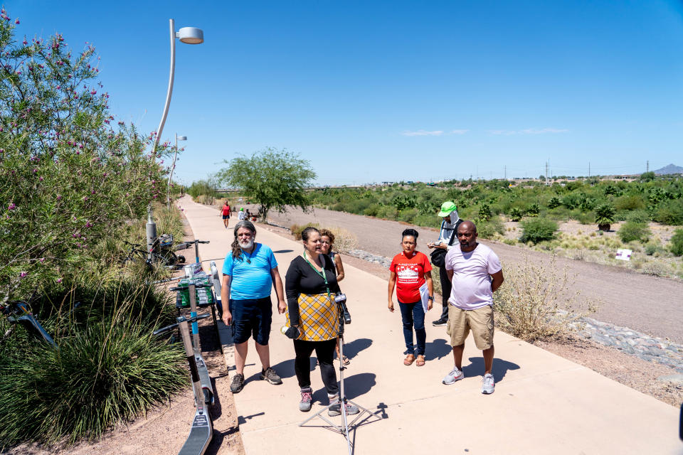 Elizabeth Venable (second from left), an organizer with Fund for Empowerment, speaks during a press conference advocating for unhoused people living in an encampment along the Rio Salado riverbed in Tempe on Aug. 31, 2022. Tempe gave notice for people living in the river bottom to vacate by Aug. 31.