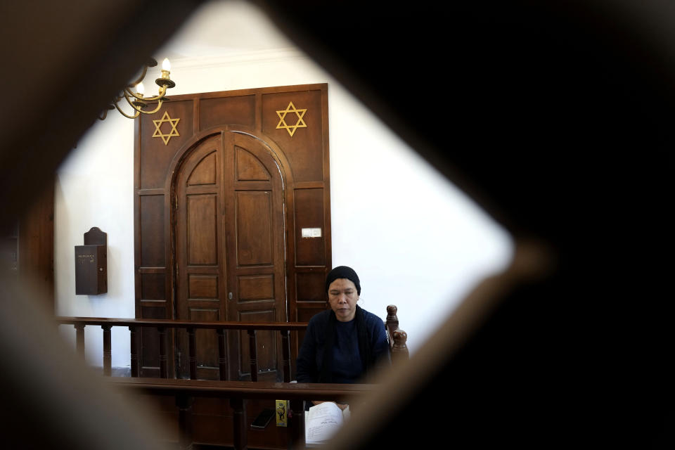 A woman prays at Shaar Hashamayim Synagogue in Tondano, North Sulawesi, Indonesia, Saturday, Oct. 14, 2023. An Indonesian rabbi at the only synagogue in the world's most populous Muslim-majority nation, called on Saturday for peace and an an end to the fightings in Israel and Gaza. (AP Photo/Tatan Syuflana)