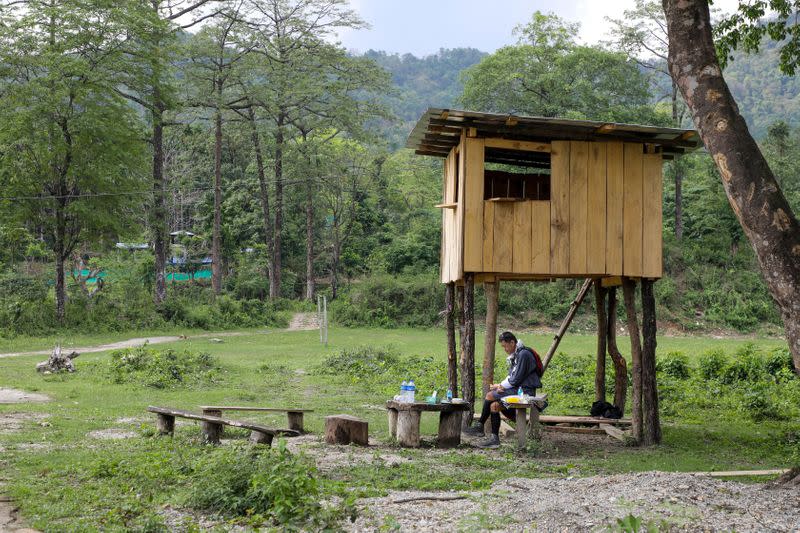 Bhutan's King Jigme Khesar Namgyel Wangchuck takes his lunch at a security outpost during his visit to remote villages to oversee measures to contain the spread of the coronavirus disease (COVID-19), in Tempaling