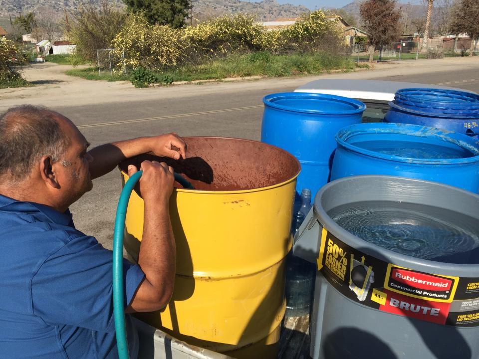 Norberto Orosco of East Porterville fills drums in the back of his pickup truck with with water from a 5,000 tank, one of two in the town providing non-potable water — for washing clothes, showering and flushing toilets, but not for drinking. Herrera’s home is one of nearly 600 in the town that have had their wells run dry due to the Valley’s drought.