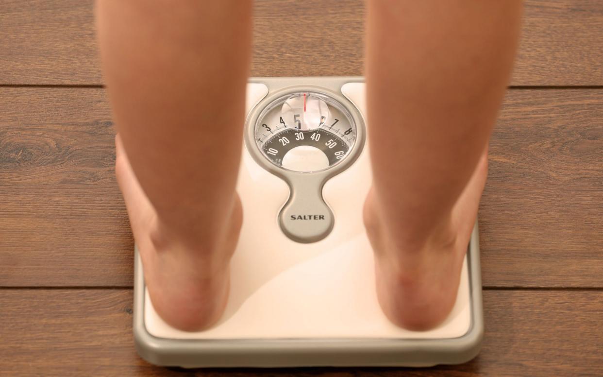 Picture posed by model File photo dated 03/03/14 of an 11 year old girl using a set of weighing scales. A tax on sugar-loaded food and sweets could help tackle the waistlines of Britain's children and save the NHS billions of pounds, according to a new report. PA Photo. Issue date: Thursday August 27, 2020. The Institute for Public Policy Research (IPPR), a left-wing think tank, has called on ministers to go further than the Government's own obesity crackdown measures by extending its sugar tax, which is already applied to fizzy drinks, to unhealthy foods. See PA story POLITICS Obesity. Photo credit should read: Chris Radburn/PA Wire - PA/PA