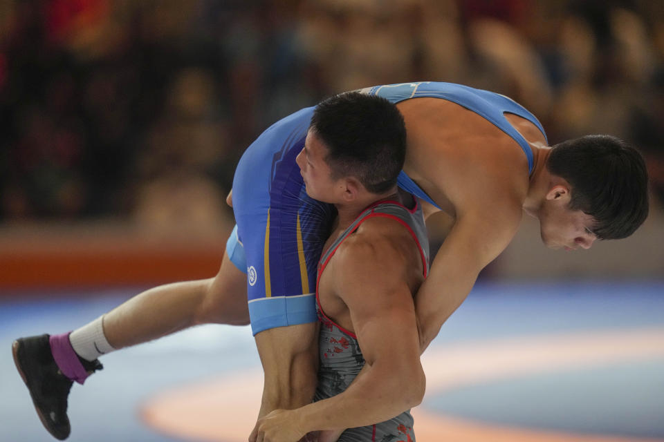 Vietnam's Ngo Thesao, red, competes against Laos' Sihavong Dawsonstephen during their men's freestyle 70-kilogram final wrestling match at the 32nd Southeast Asian Games in Phnom Penh, Cambodia, Tuesday, May 16, 2023. (AP Photo/Tatan Syuflana)