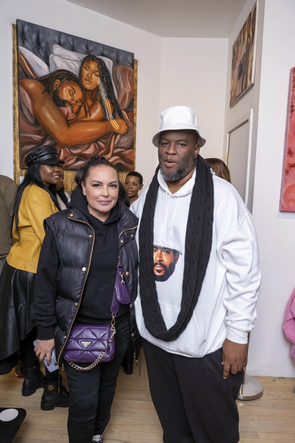 Angie Martinez and Salaam Remi posing for picture.