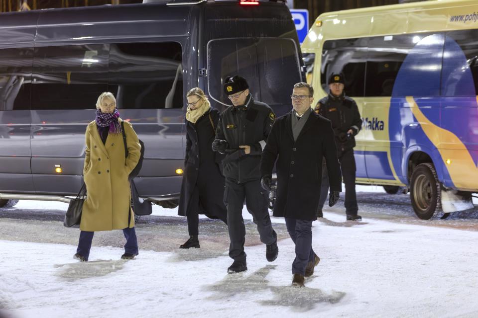 Finland's Prime Minister Petteri Orpo, second right, and Chief of the Finnish Border Guard, Lieutenant General Pasi Kostamovaara, center, during a visit to the Vartius border crossing station in Kuhmo, eastern Finland, Monday Nov. 20, 2023. The prime minister on Monday said the country may need to take further actions on its border with Russia after closing four border crossings in an attempt to stem a recent increase in asylum-seekers. (Hannu Huttu/Lehtikuva via AP)