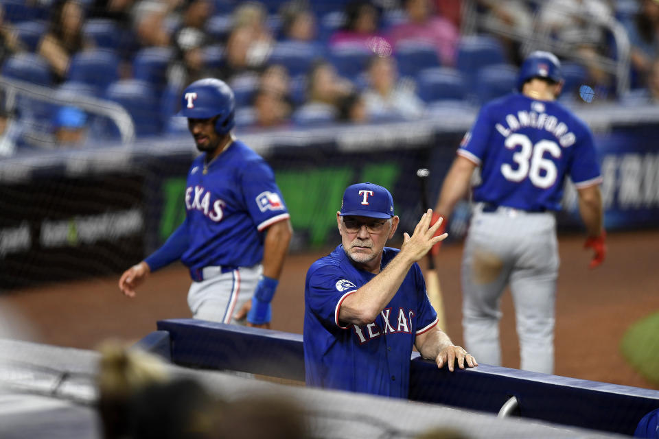 Texas Rangers manager Bruce Bochy, center, challenges a force out play during the ninth inning of a baseball game against the Miami Marlins, Saturday, June 1, 2024, in Miami. (AP Photo/Michael Laughlin)