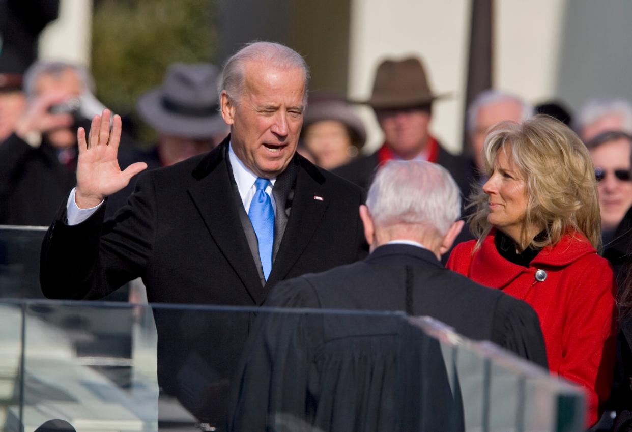Vice President-elect Joe Biden, with his wife Jill at his side, takes the oath of office from Justice John Paul Stevens, as his wife holds the Bible at the U.S. Capitol in Washington, Tuesday, Jan. 20, 2009.