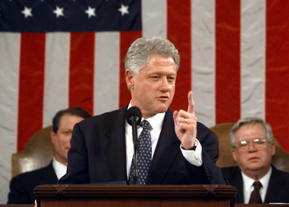 FILE - In this Jan. 19, 1999 file-pool photo, President Bill Clinton gestures while giving his State of the Union address on Capitol Hill in Washington. Is “strong” losing its strength? Presidents of both parties have long felt compelled to sum up the state of the union with a descriptive word or two in their State of the Union addresses. Mostly the same word. For many years now, “strong” has been the go-to adjective. Vice President Gore, left, and House Speaker Dennis Hastert of Ill. listen. (AP Photo/Win McNamee, File-Pool)