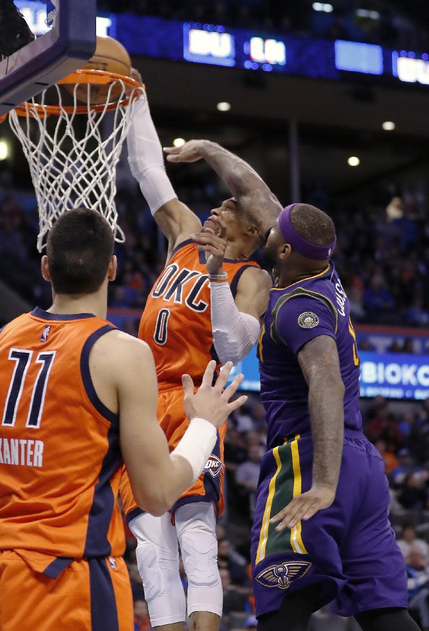 Oklahoma City Thunder guard Russell Westbrook (0) is fouled by New Orleans Pelicans forward DeMarcus Cousins (0) during the second half of an NBA basketball game in Oklahoma City, Sunday, Feb. 26, 2017. Oklahoma City won 118-110. (AP Photo/Alonzo Adams)