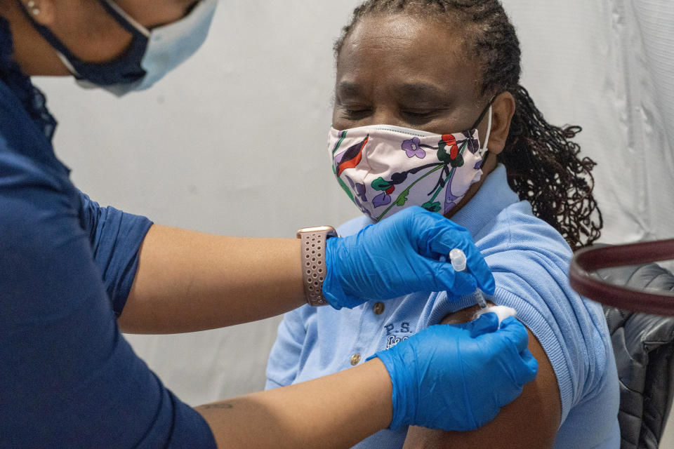 Dorrit Crawford, of Brooklyn, receives the first dose of the coronavirus vaccine at a pop-up COVID-19 vaccination site at the God's Battalion of Prayer Church, Wednesday, Feb. 3, 2021, in the Brooklyn borough of New York. SOMOS and Elderplan volunteer nurses are expected to vaccinate up to 500 older New Yorkers who attend the church or live in surrounding areas. (AP Photo/Mary Altaffer)