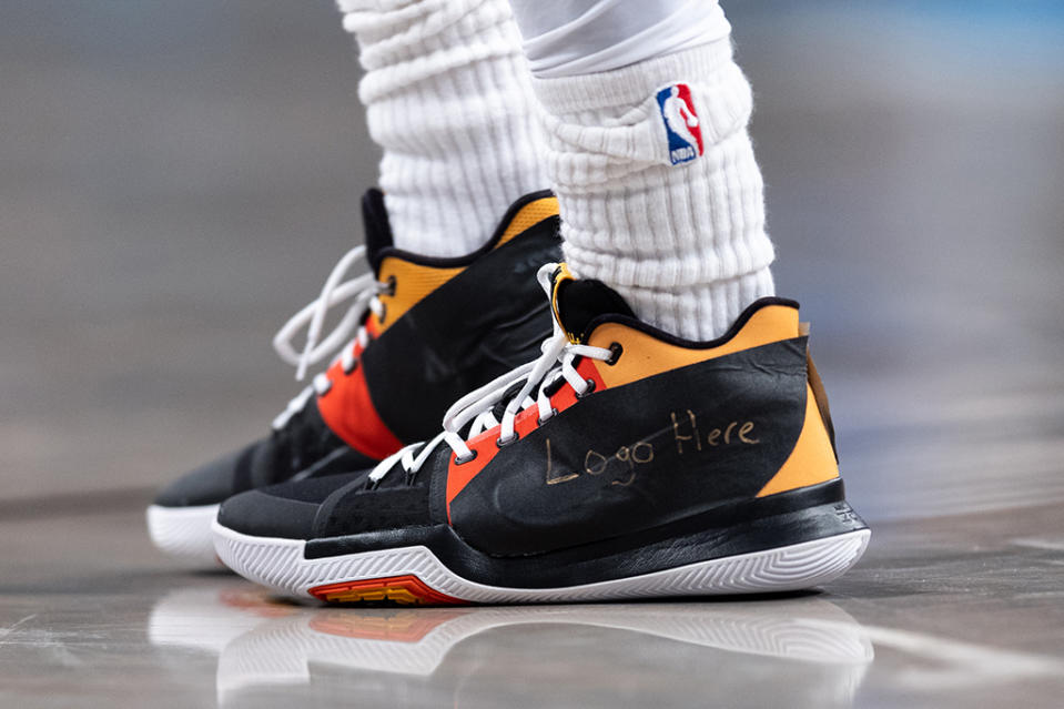 Kyrie Irving’s Nike Kyrie 3 “Raygun” with “Logo Here” written on tape covering the Swoosh branding. - Credit: Dustin Satloff/Getty Images