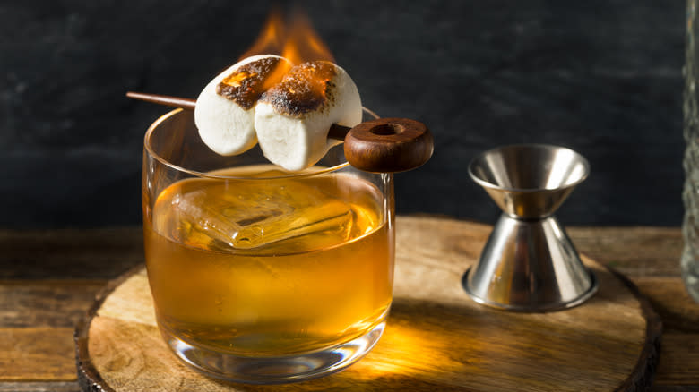 Cocktail with flaming marshmallow garnish
