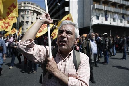 A protester shouts slogans as he marches towards the parliament with others during a general labour strike in Athens April 9, 2014. REUTERS/Yorgos Karahalis