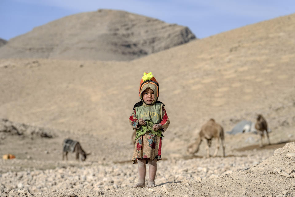 A child stands outside her home in a village in a remote region of Afghanistan, on Friday, Feb. 24, 2023. In a nearby village, a baby was orphaned during a U.S. raid in 2019. A Marine who adopted her claims her parents were foreign fighters. But villagers say they were innocent farmers caught in the fray. (AP Photo/Ebrahim Noroozi)