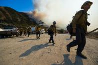 A crew prepares to clear a hot spot at the Blue Cut Fire near Wrightwood, California